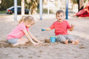 Kids playing in the sand during summer.